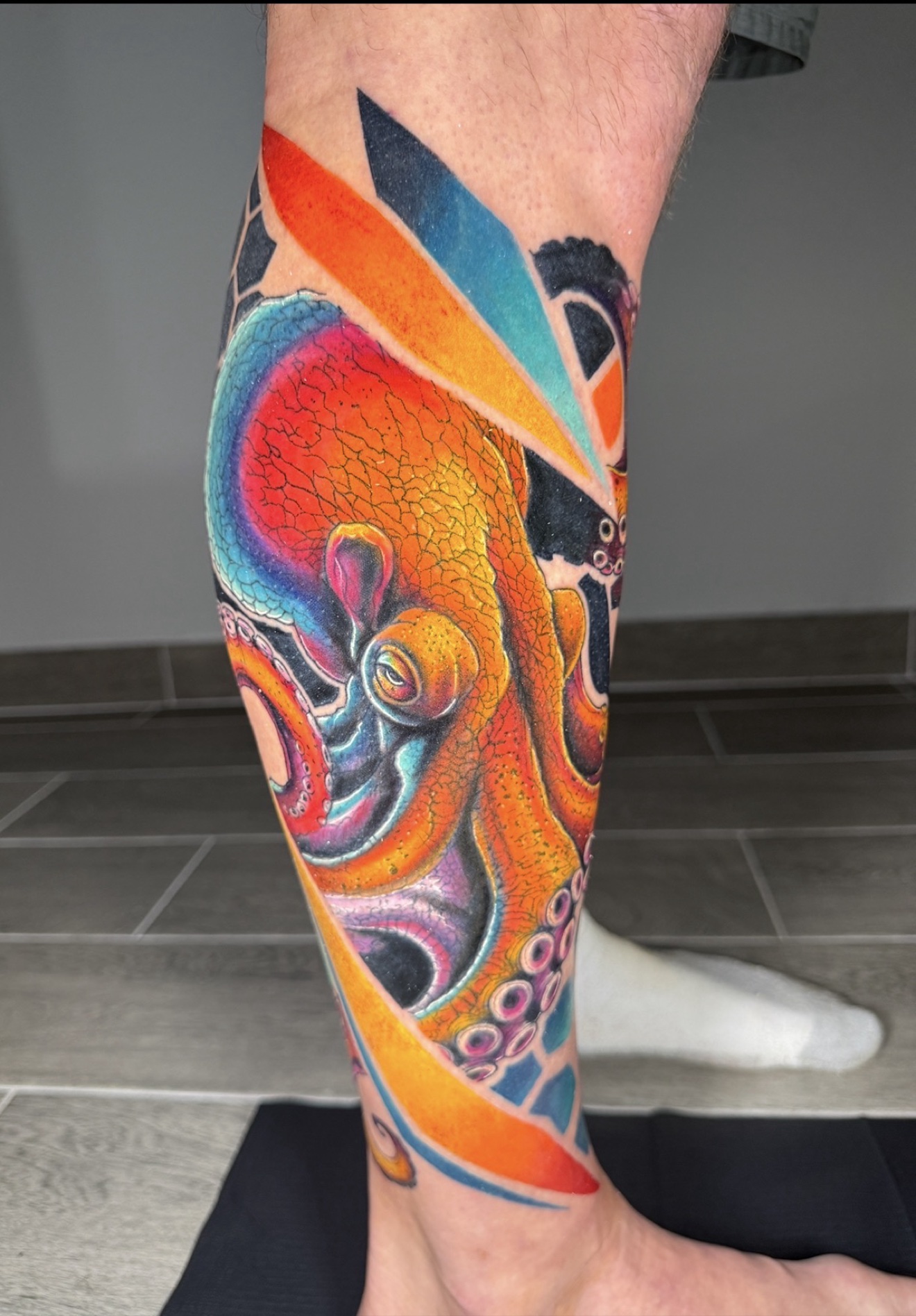 Color octopus tattoo on calf by Jorge Moreira at Moreira Ink Tattoo Shop, Lake Alfred FL