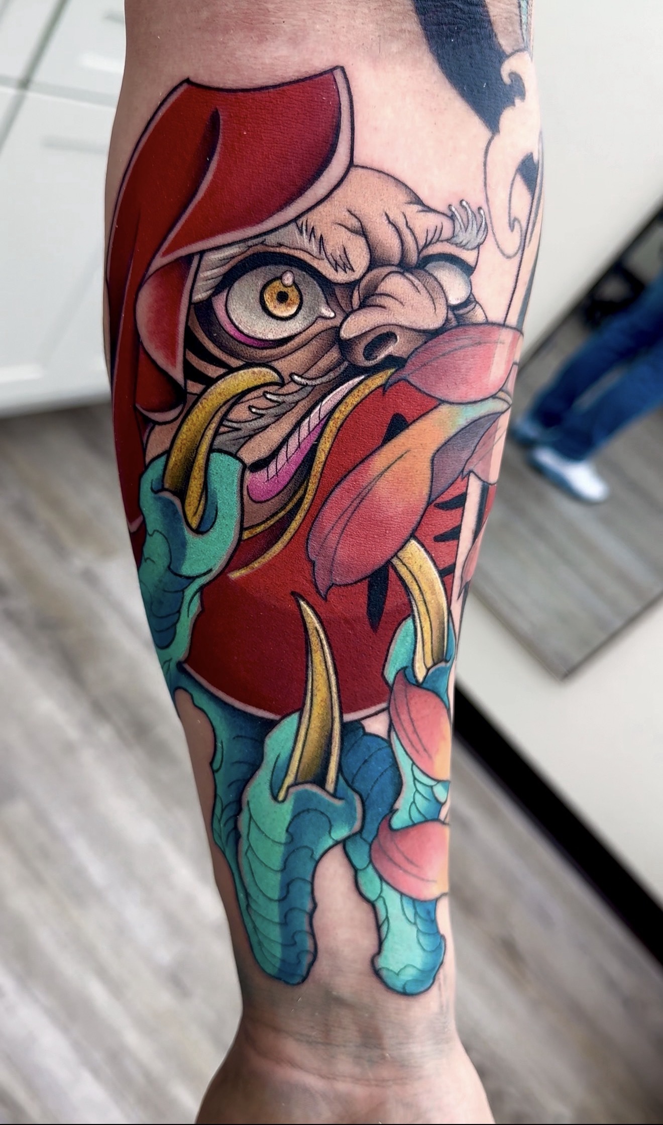 Color Daruma with dragon claws forearm tattoo by Jorge Moreira at Moreira Ink Tattoo Shop, Lake Alfred FL