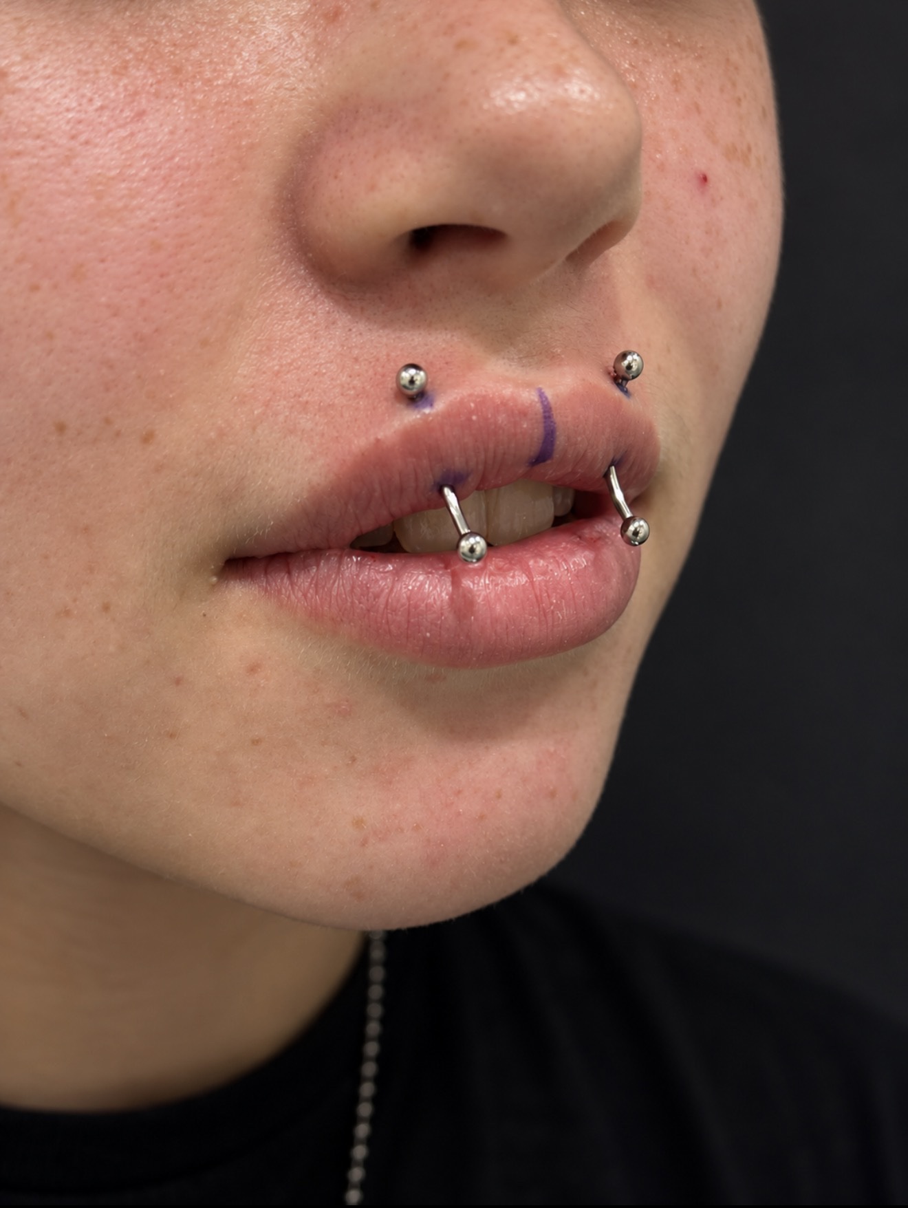 Fresh lip piercing with titanium jewelry by Megan Cooper