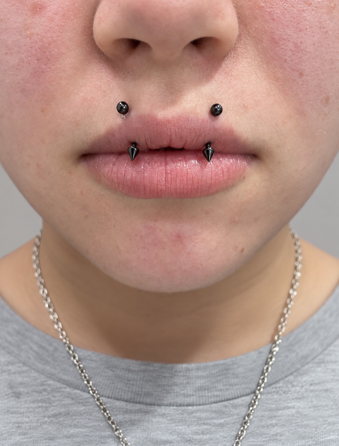 Lip piercing with spiked jewelry by Megan Cooper